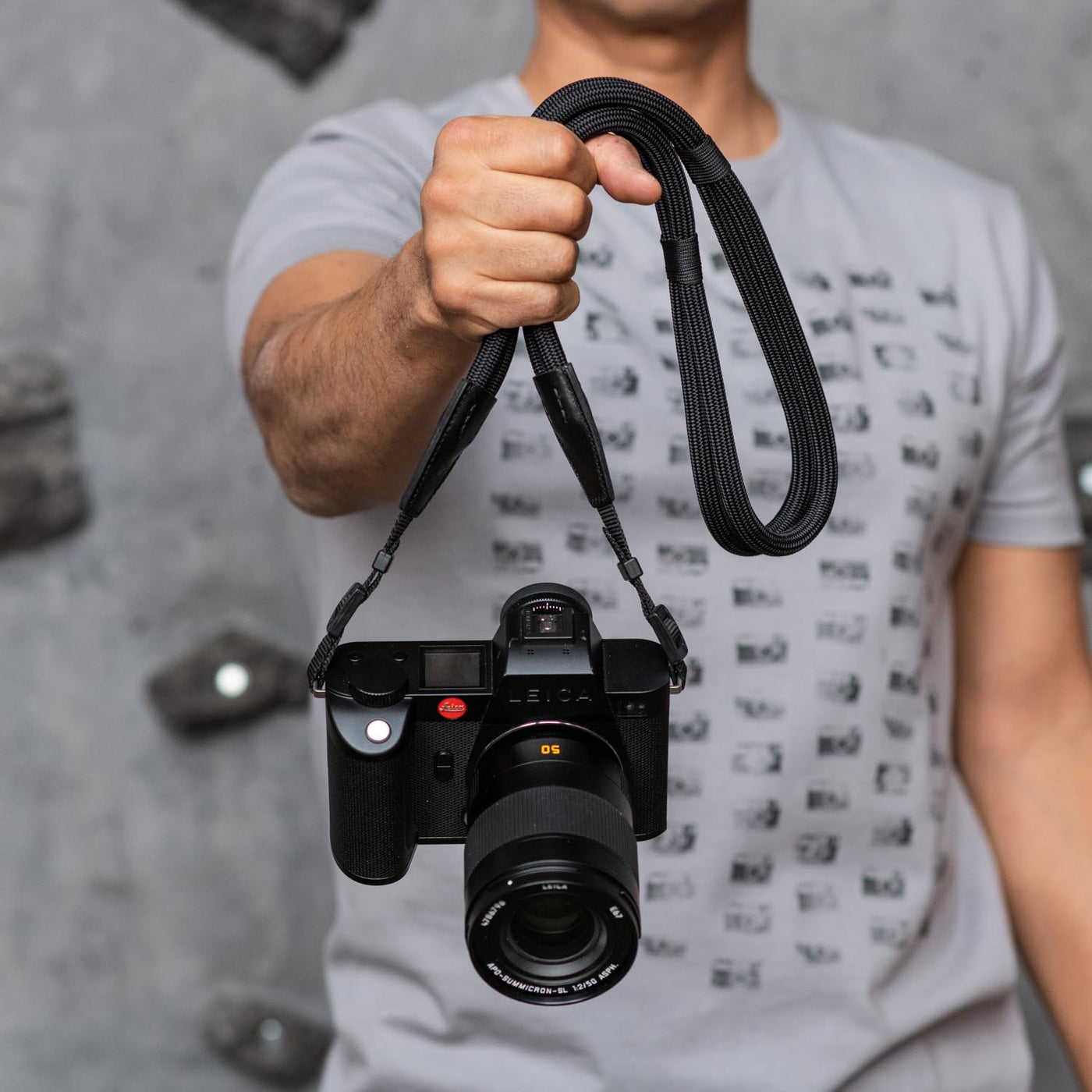 Photographer holding a Leica camera by the Leica Double Rope Strap 