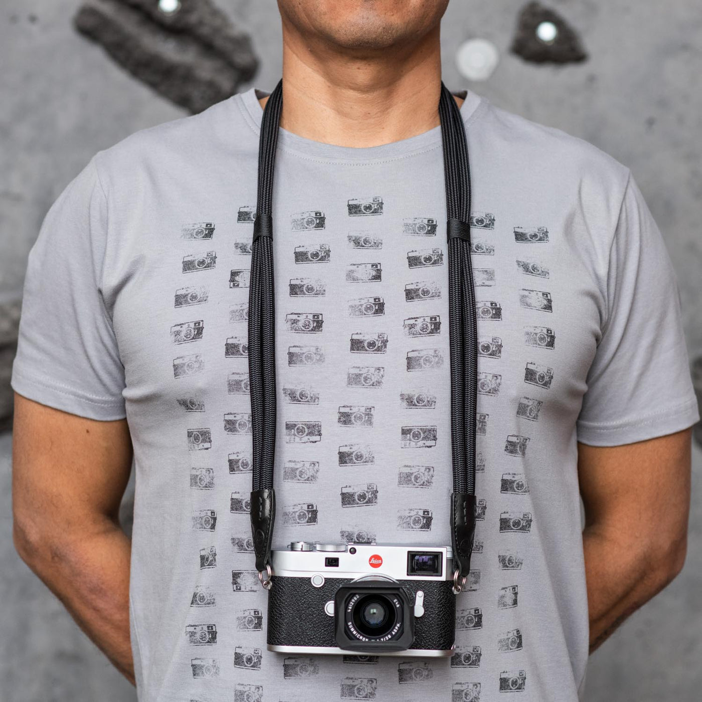 Photographer wearing Leica Double Rope Strap around his neck 