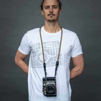 Photographer wearing retro camera around the neck with Rope Camera Strap 