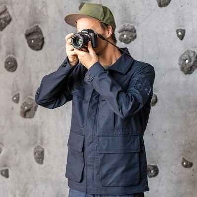 Photographer using a Sony camera wearing a navy field jacket 