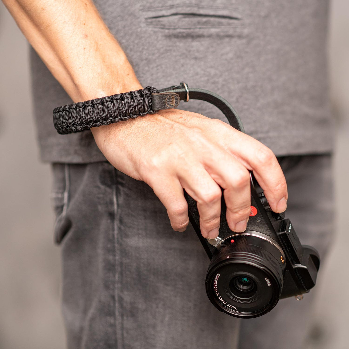 Black Leica Paracord Hand Strap around a photographer's wrist 