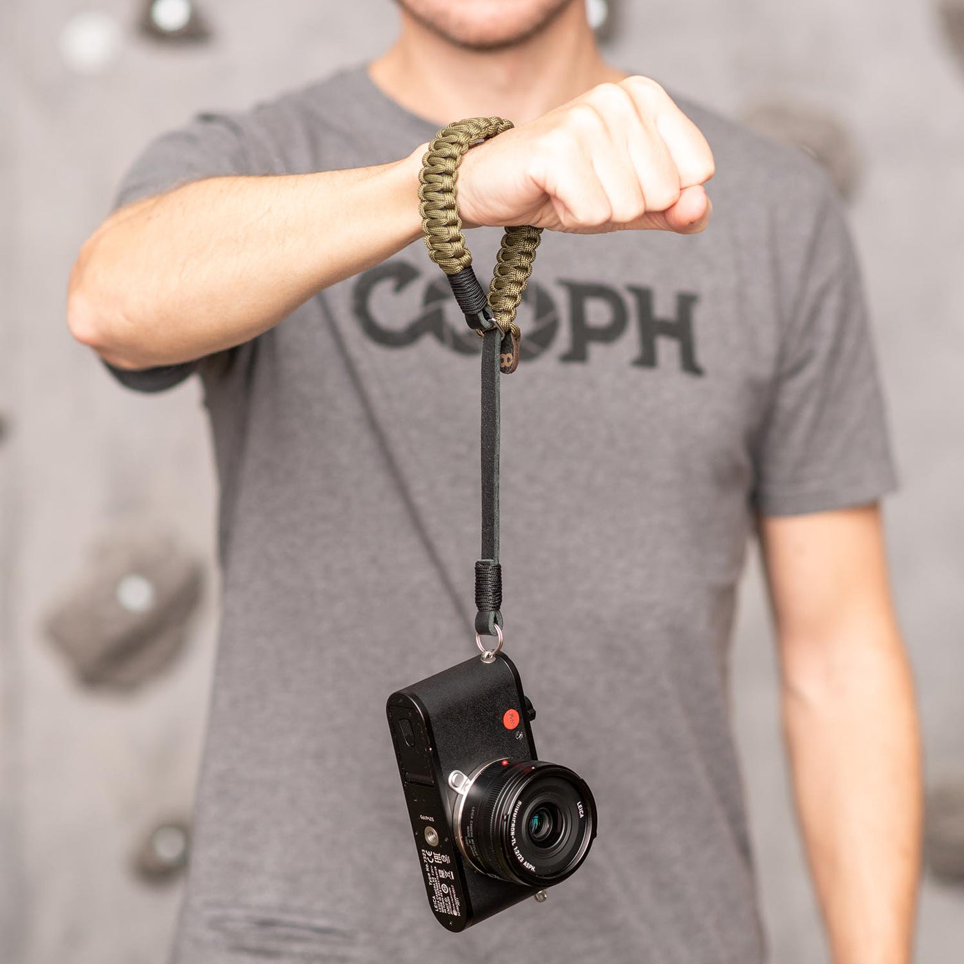 Olive Leica Paracord Hand Strap around a photographer's wrist 