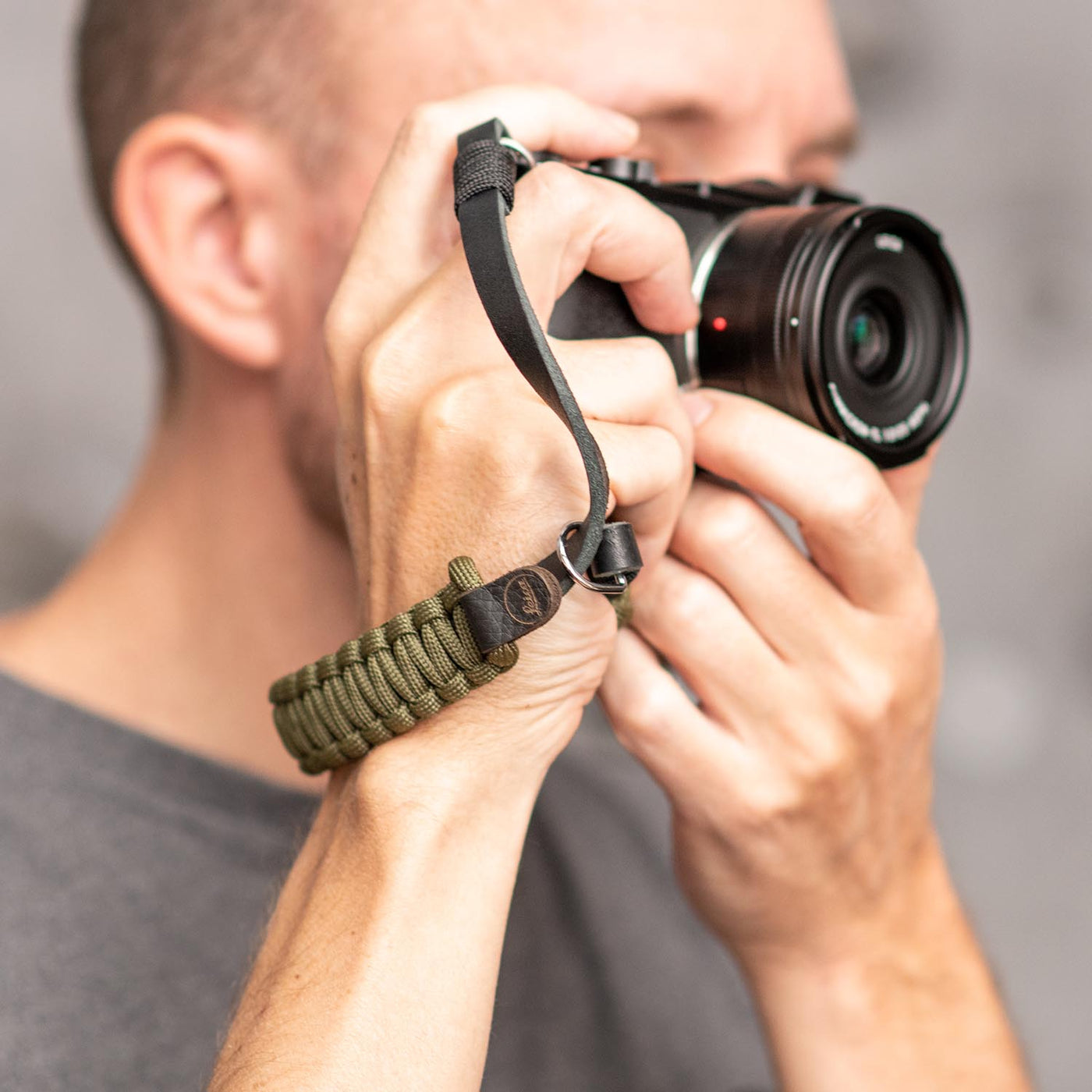 Photographer using Leica camera with Leica Paracord Hand Strap 