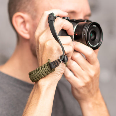 Photographer using Leica camera with Leica Paracord Hand Strap 
