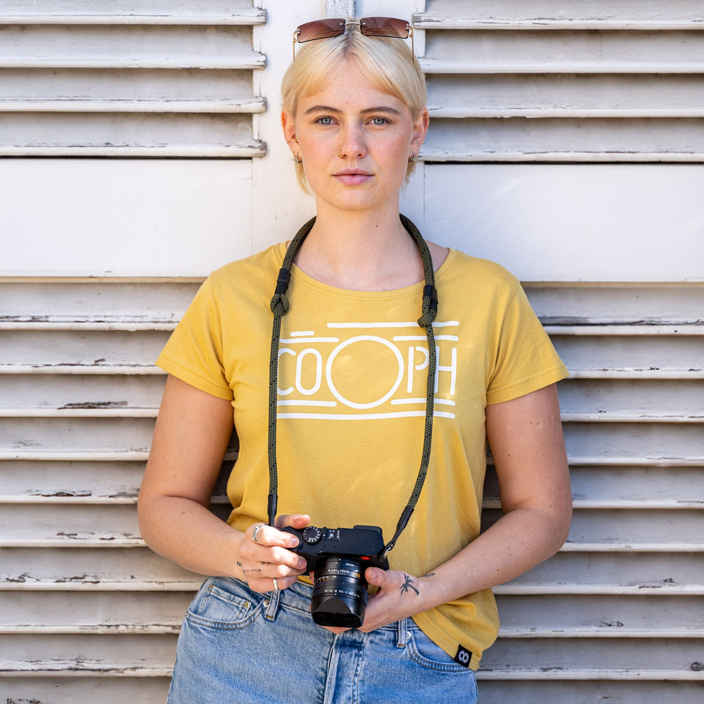 Female photographer holding Leica Camera with Adjustable Rope Strap around her neck 
