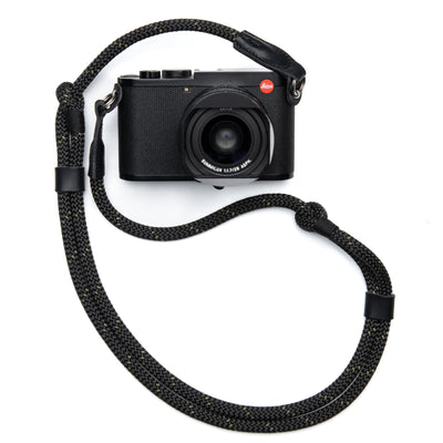 Black Leica Camera with lens and cover with a Adjustable Rope Strap attached with steel rings  