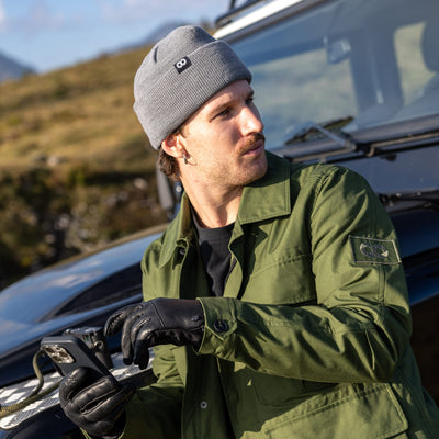 Photograher in field jacket and gray edc beanie in natural setting 