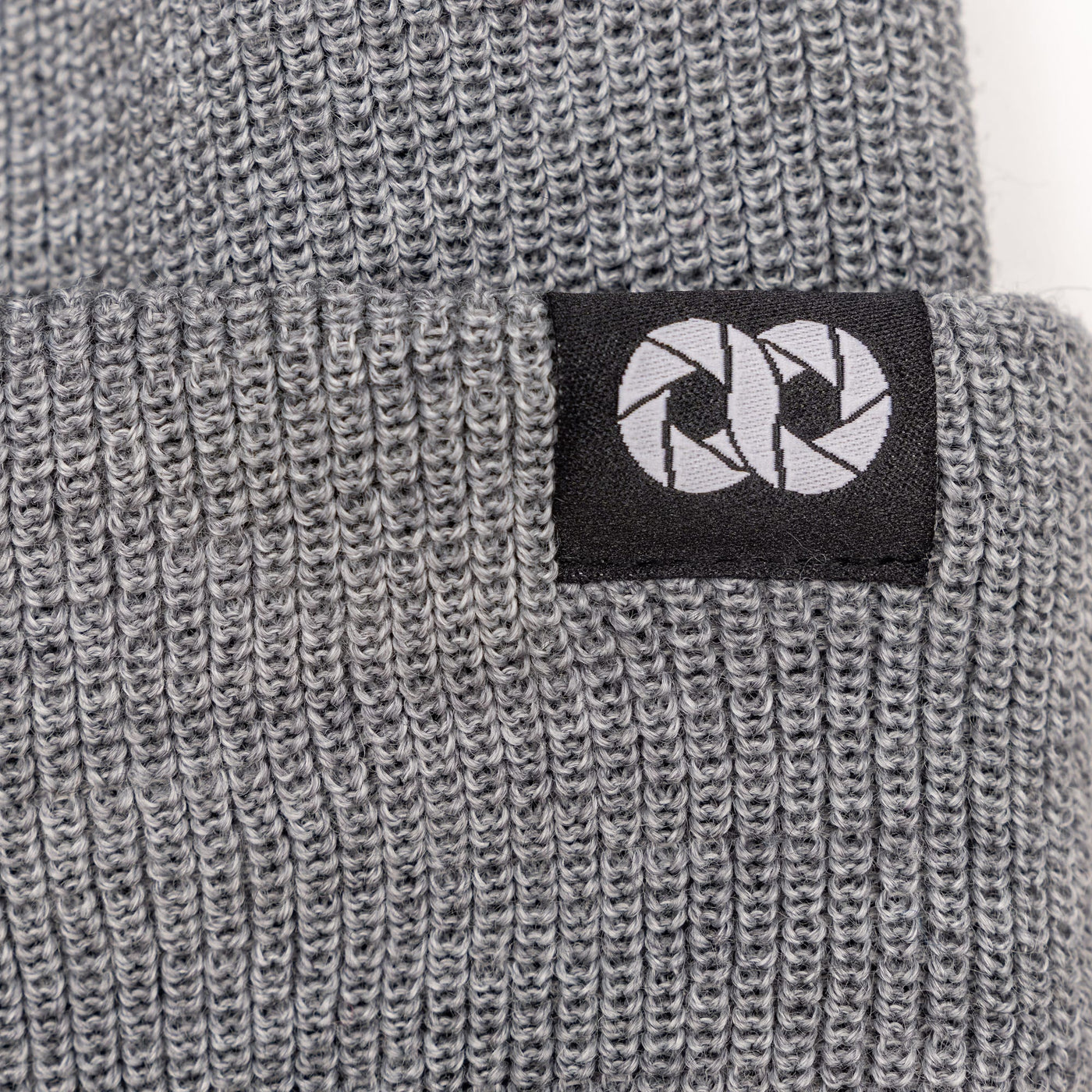 Gray knit beanie with a black label featuring  white cooph logo on a white background --big 