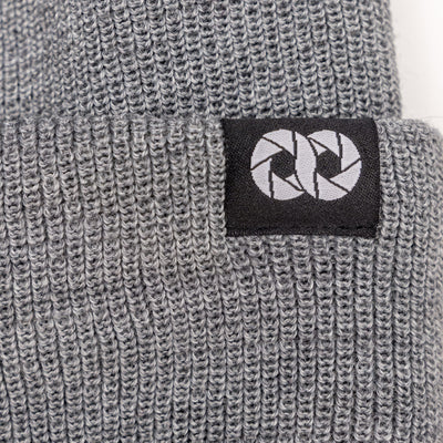Gray knit beanie with a black label featuring  white cooph logo on a white background --big 