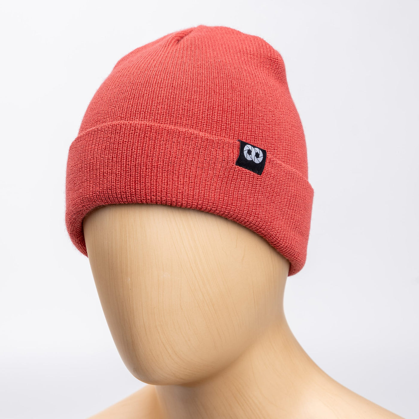 Salmon edc beanie with cooph logo on a mannequin head against a light gray background 