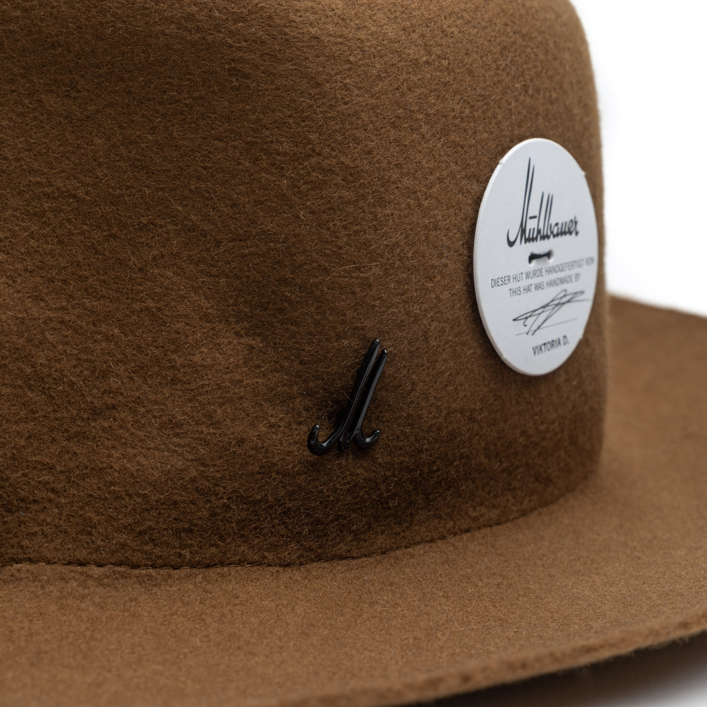 Close-up of the Mühlbauer pin which is attached on the side of the hat. 