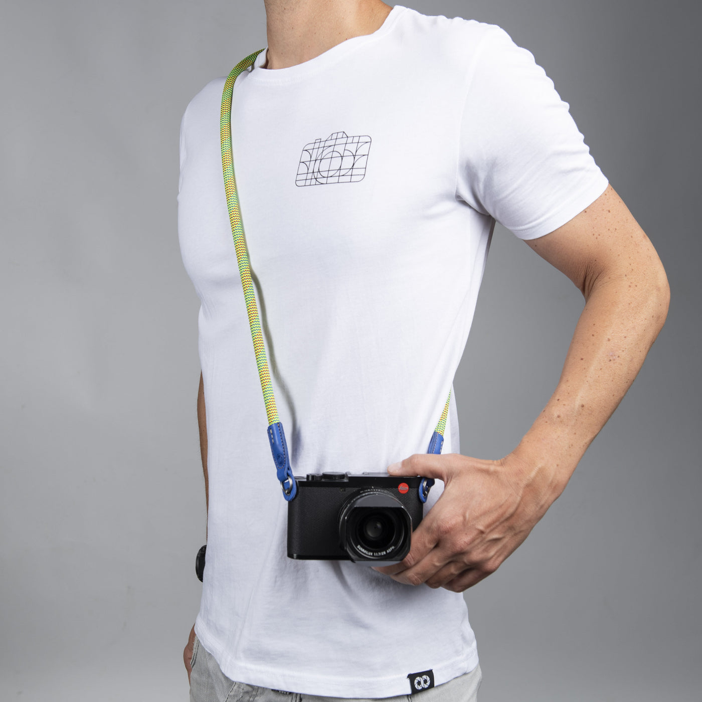 Photographer wearing beers and camera rope strap around shoulder with Leica camera 