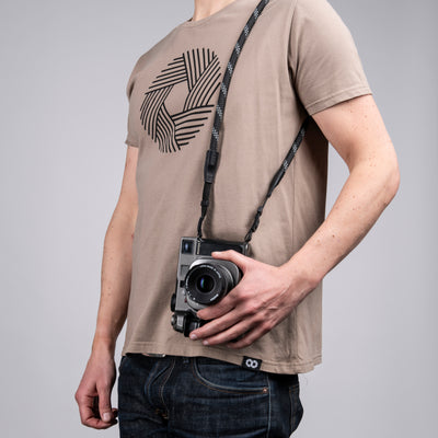 Leica camera on a photographer's hip held with charcoal rope strap 