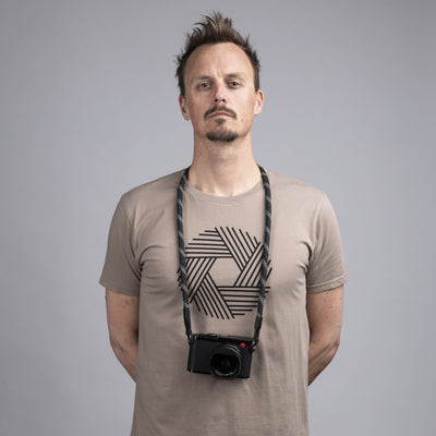 Photographer wearing a leica camera around the neck with Rope Camera Strap 