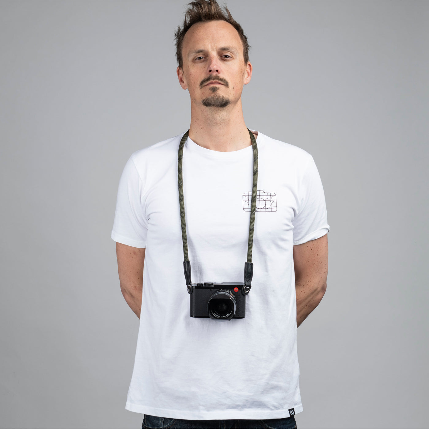 Photographer wearing a leica camera around the neck with Rope Camera Strap  