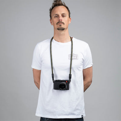 Photographer wearing a leica camera around the neck with Rope Camera Strap  