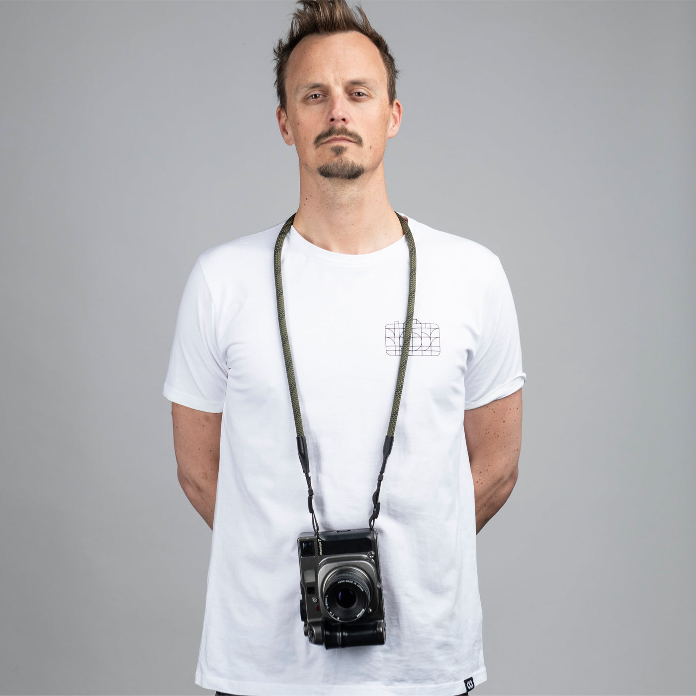 Photographer wearing a camera around the neck with Rope Camera Strap 