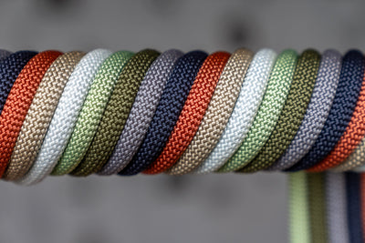 Multiple Cooph Rope Camera Straps wrapped around a pole showing a wide variety of colors