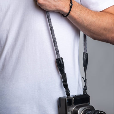 Photographer wearing the cooph rope camera strap charcoal over the shoulder  