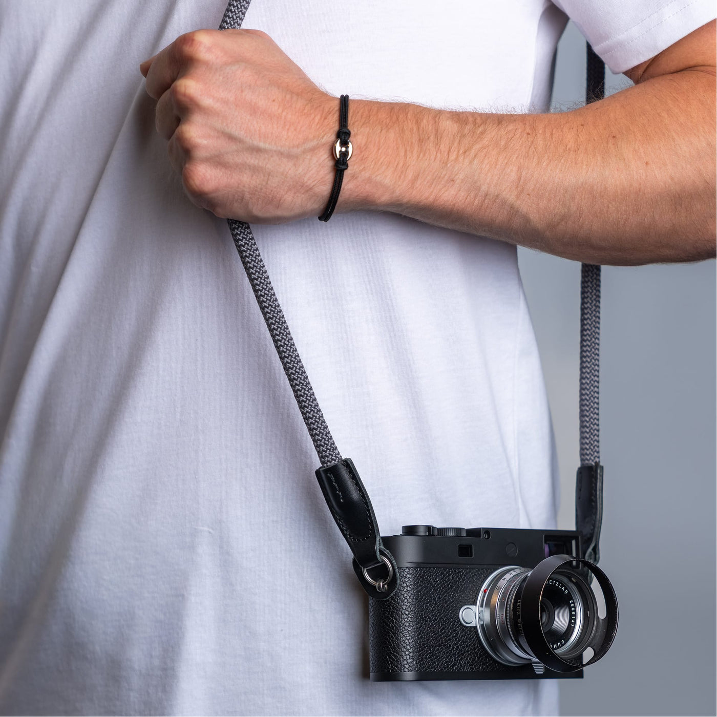Photographer wearing the cooph rope camera strap charcoal over the shoulder 