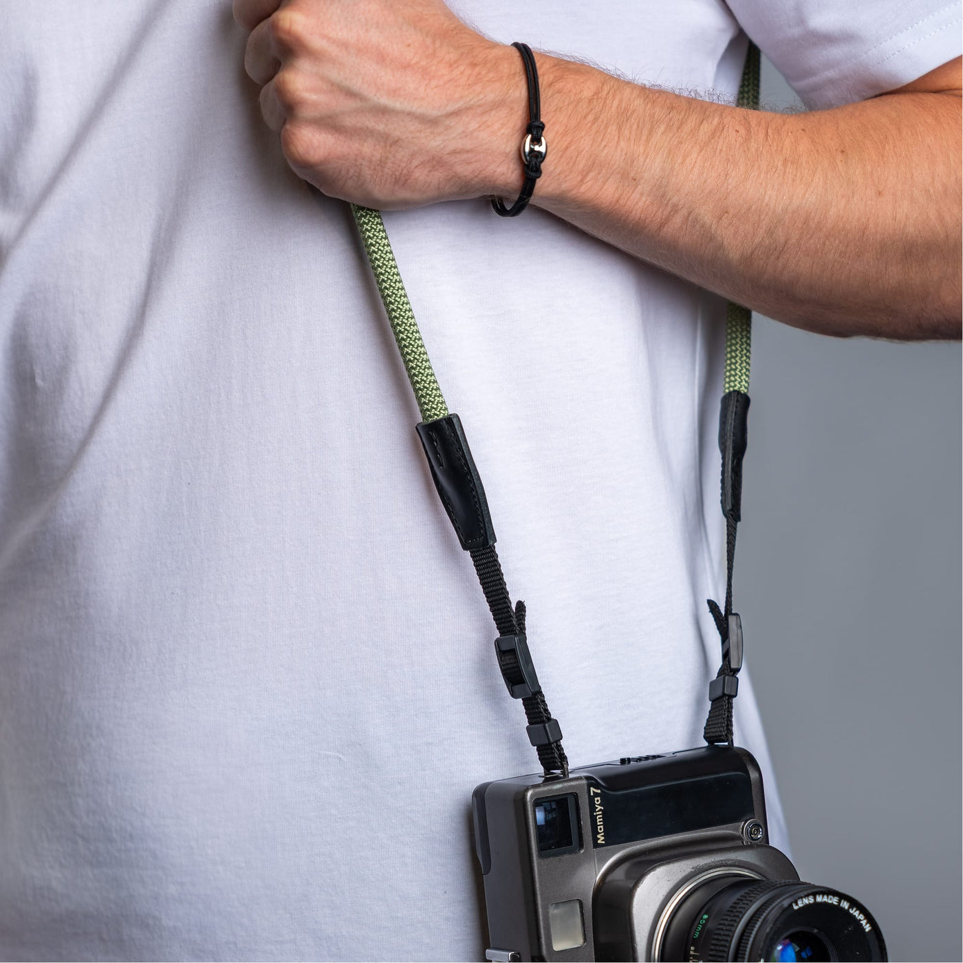 Photographer wearing the cooph rope camera strap guacamole over the shoulder 
