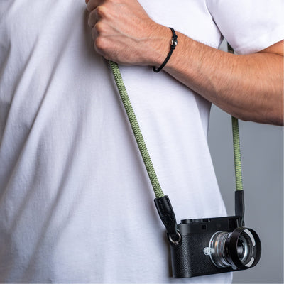 Photographer wearing the cooph rope camera strap guacamole over the shoulder