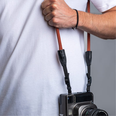Photographer wearing the cooph rope camera strap rust over the shoulder 