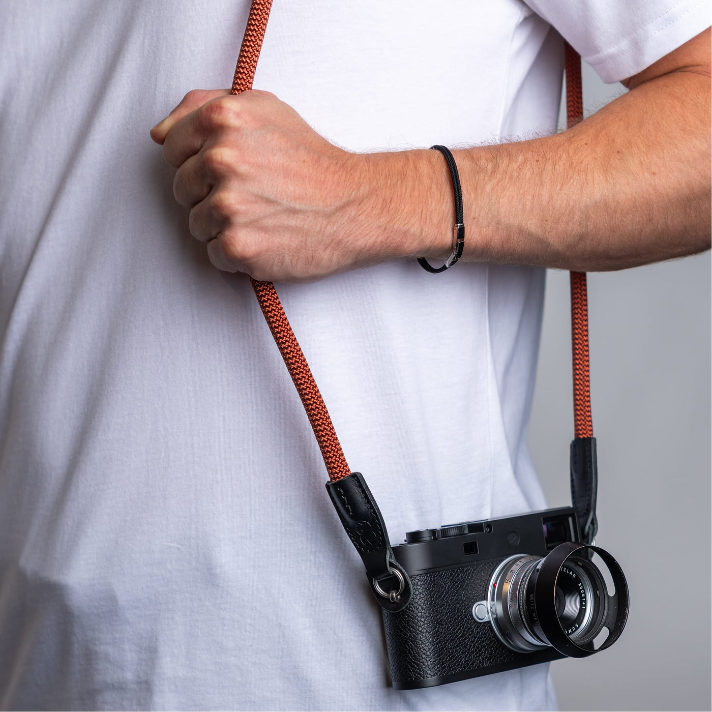 Photographer wearing the cooph rope camera strap rust over the shoulder 