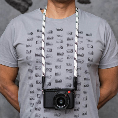 Photographer wearing leica camera around the neck with rope strap 