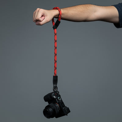 Photographer hanging Sony camera around the wrist with  Rope Hand Camera Strap 