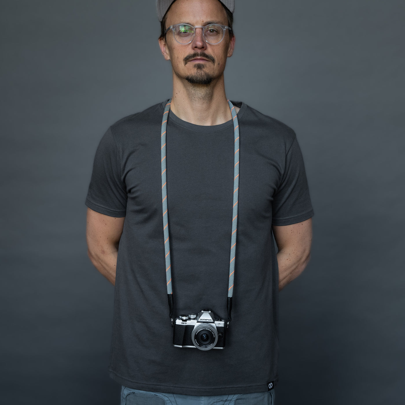 Photographer wearing Olympus camera around the neck with Rope Camera Strap 