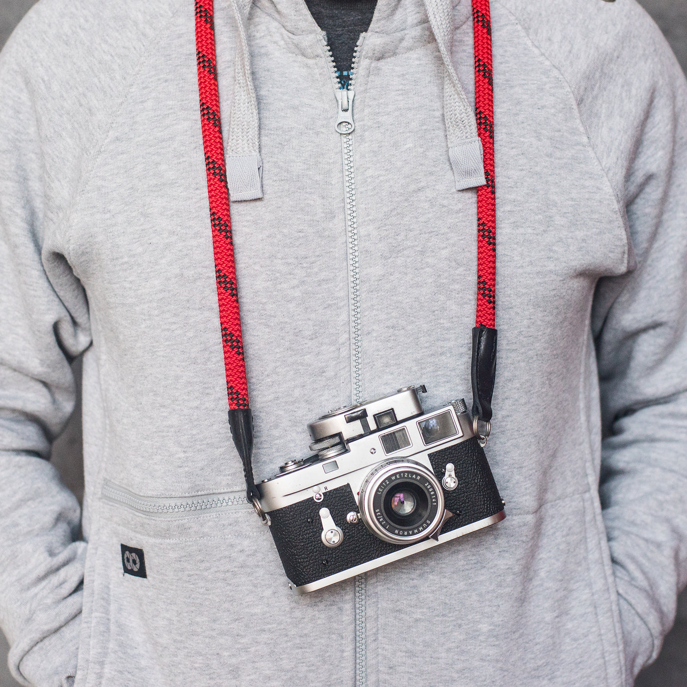 Photographer wearing camera around the neck with rope 