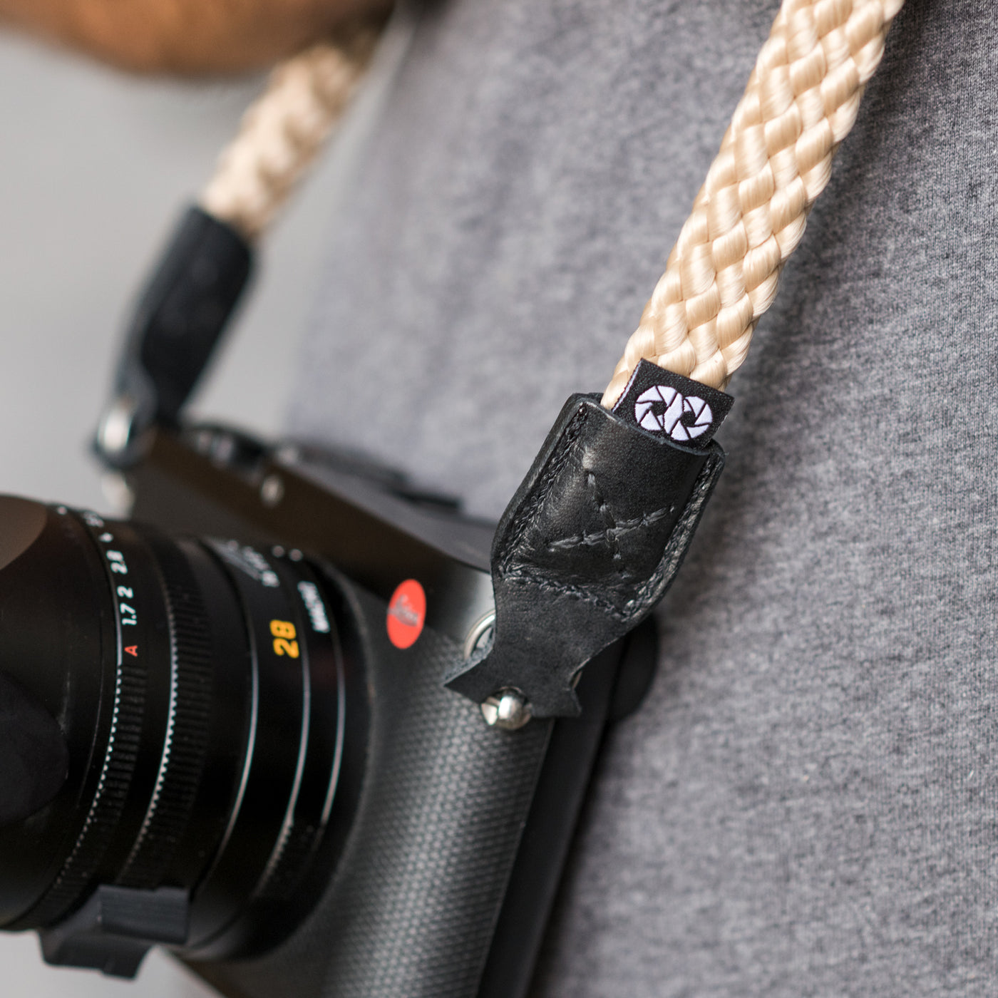 Leica camera on a photographer's hip held with braid camera strap 