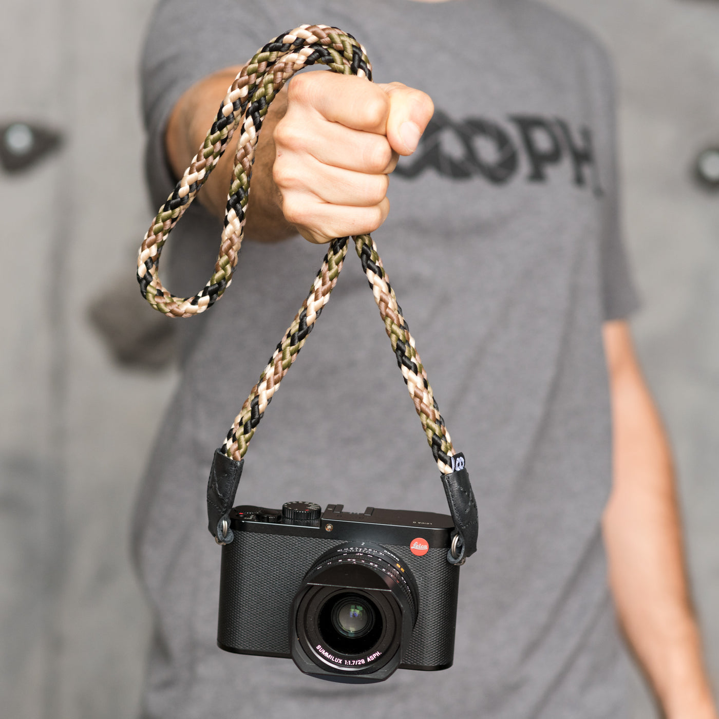 Photographer holding a camera by the strap 