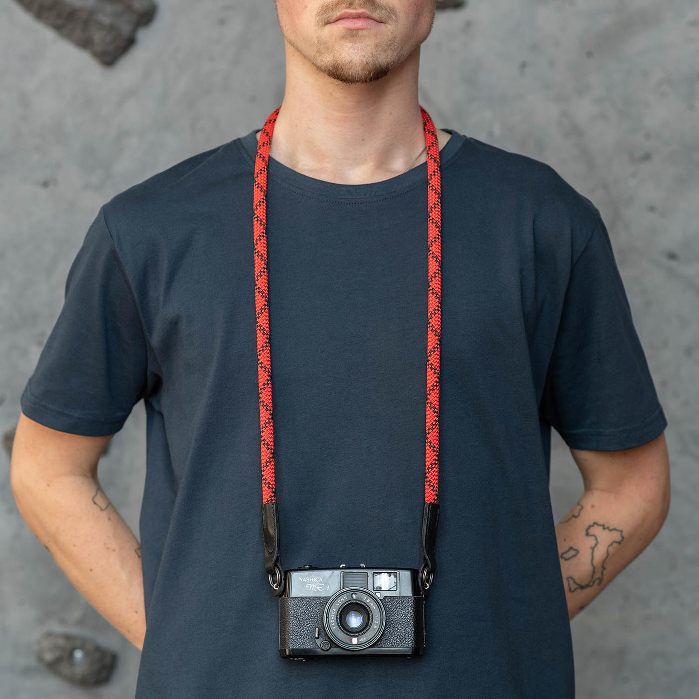 Photographer wearing retro camera around the neck with Rope Camera Strap 