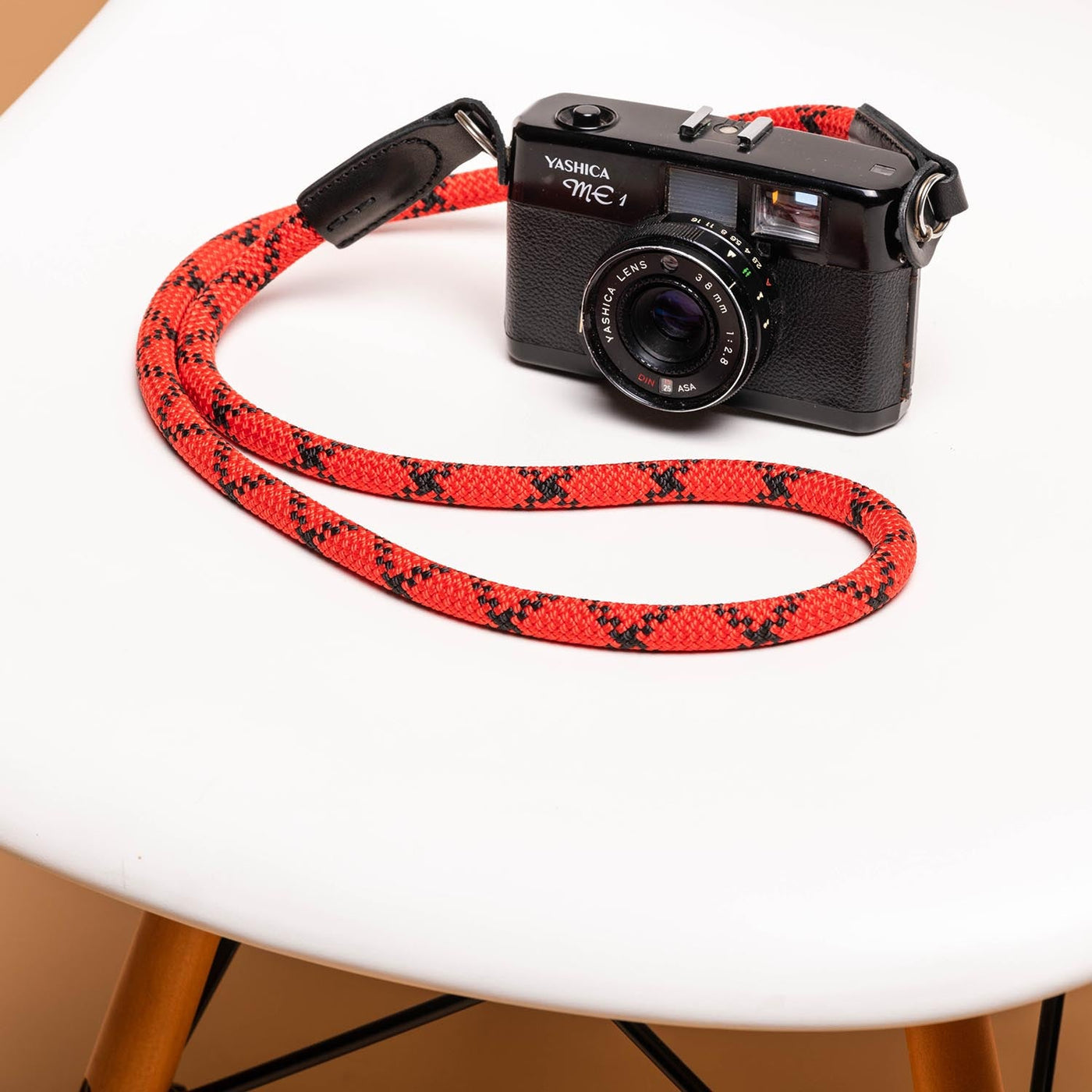 Yashica Camera on table with red Rope Camera Strap 