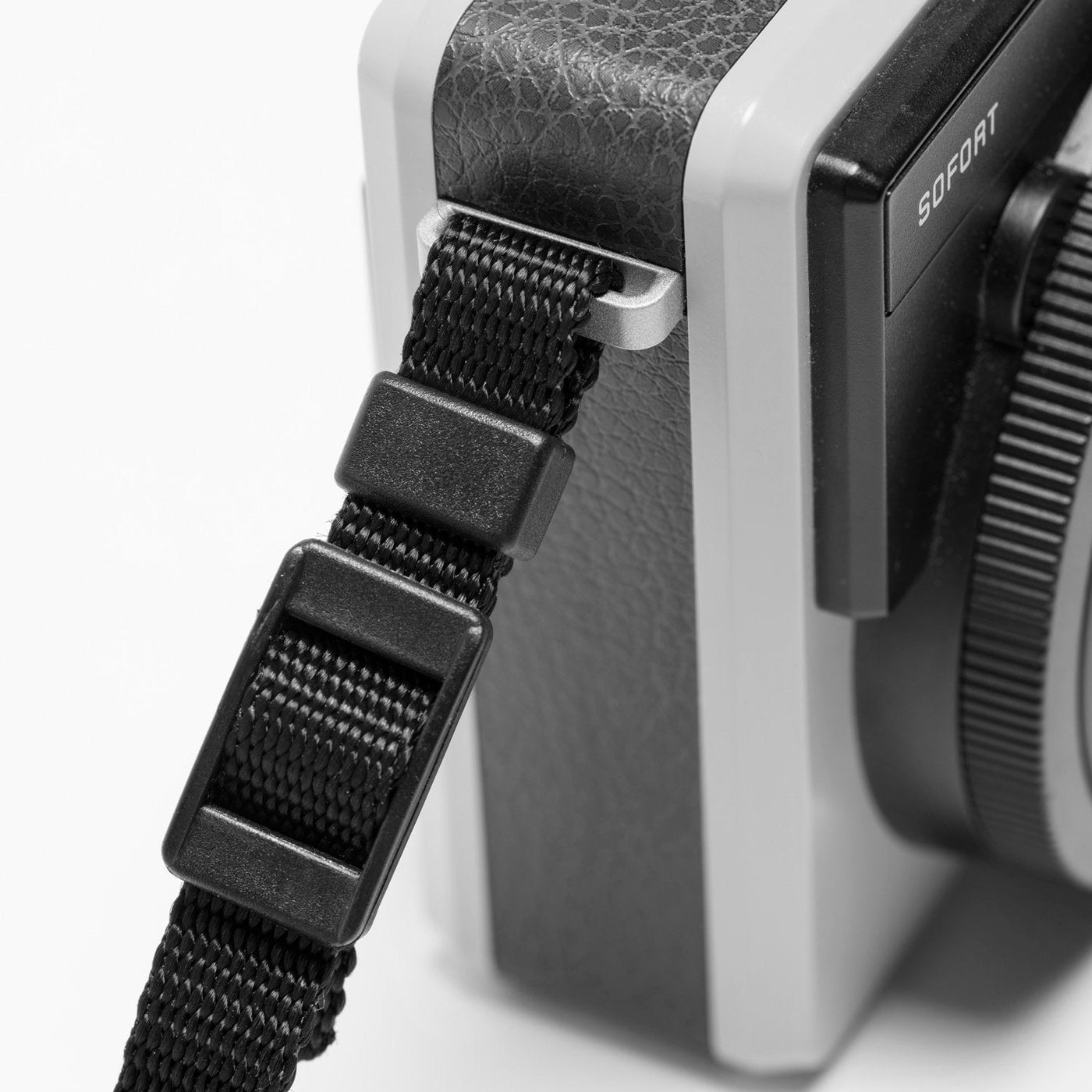 Webbing ends on rope strap attached to Leica camera 