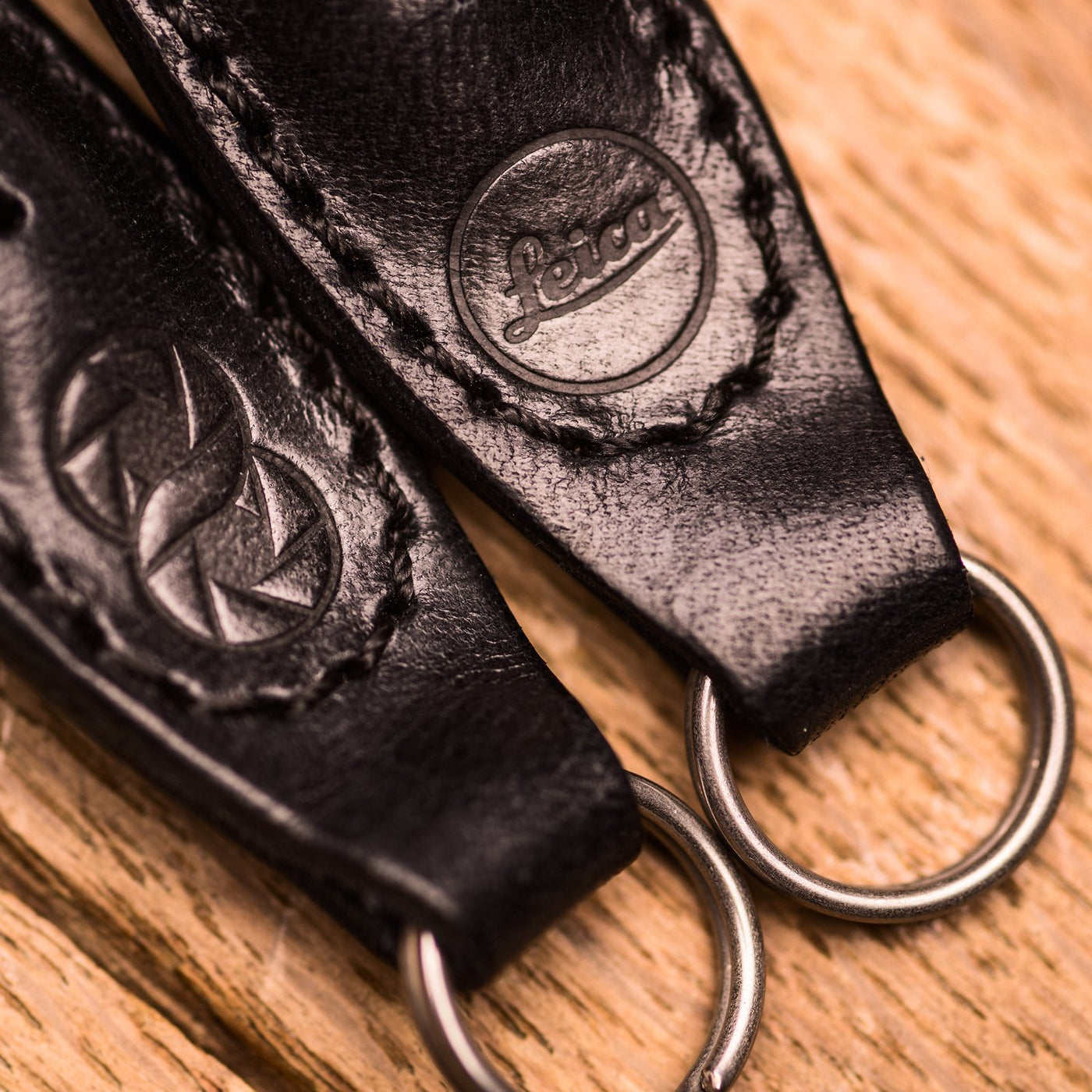 Leather ends of rope strap with steel rings and Leica embossing 