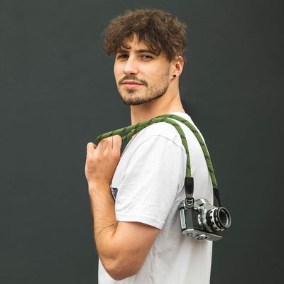 Photographer wearing retro film camera over the shoulder with Rope Camera Strap 