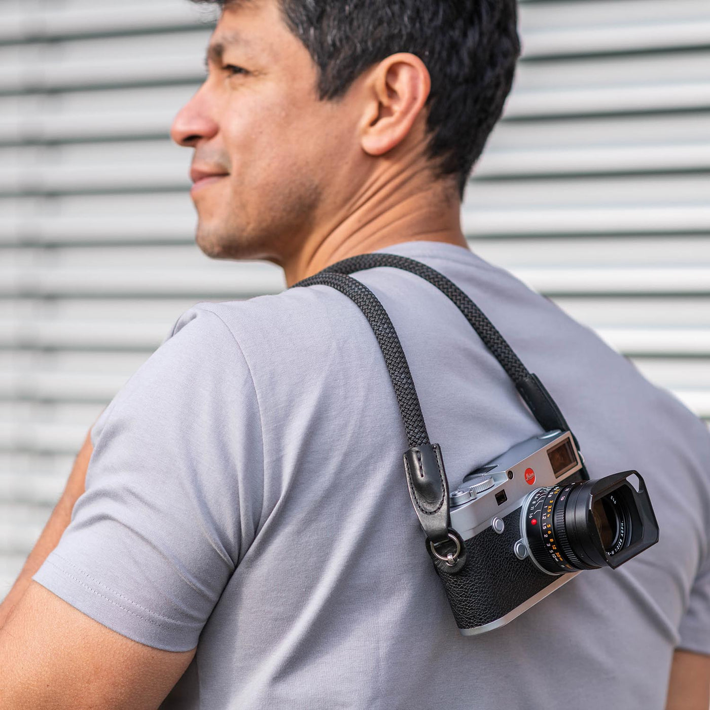 Photographer wearing Leica camera over the shoulder with  Rope Camera Strap  