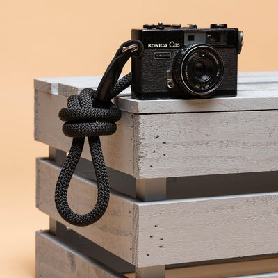 Konica Camera with a rope strap tied in a knot  