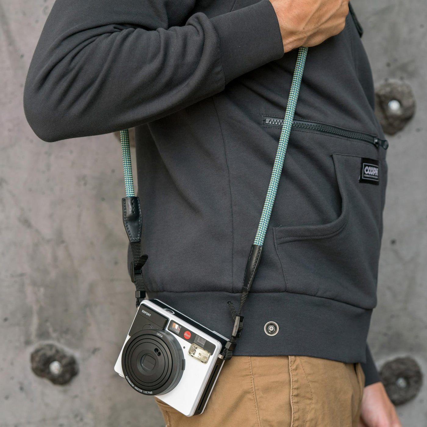 Leica camera on a photographer's hip held with rope strap 