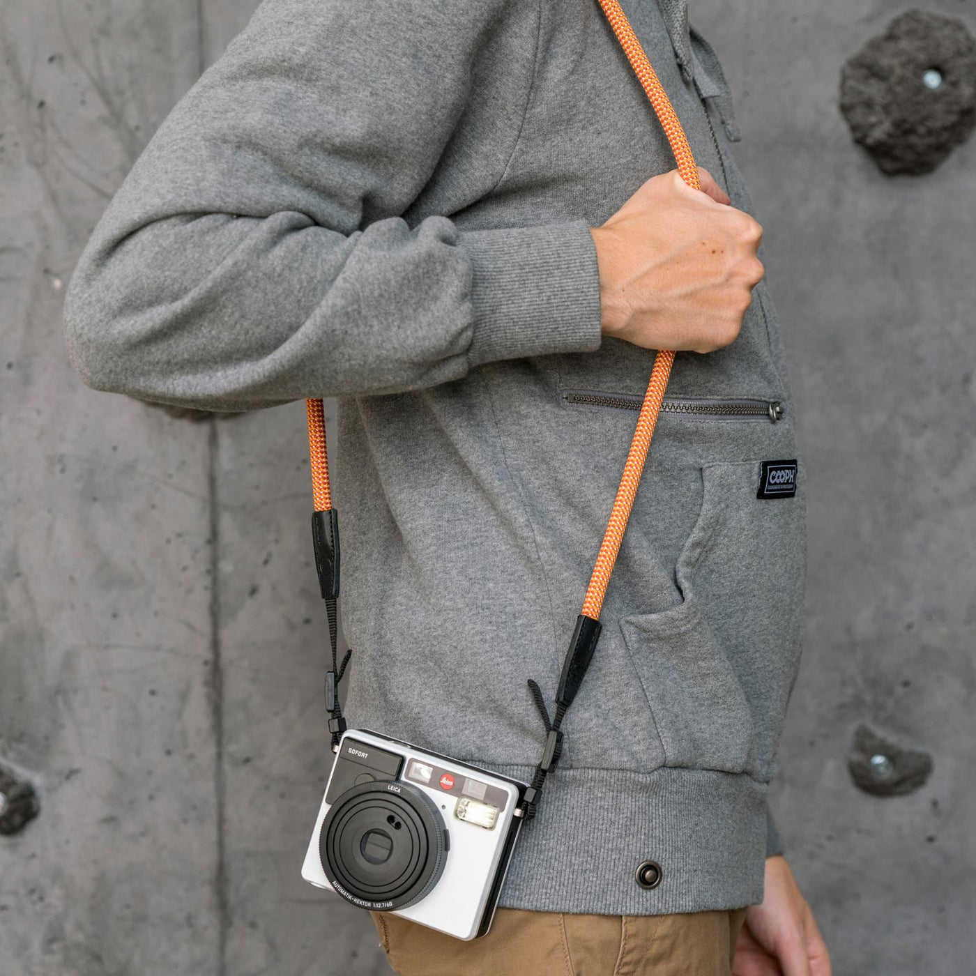 Leica camera on a photographer's hip held with rope strap 