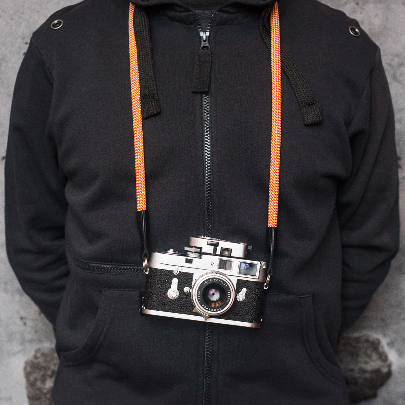 Photographer wearing camera around the neck with rope strap 